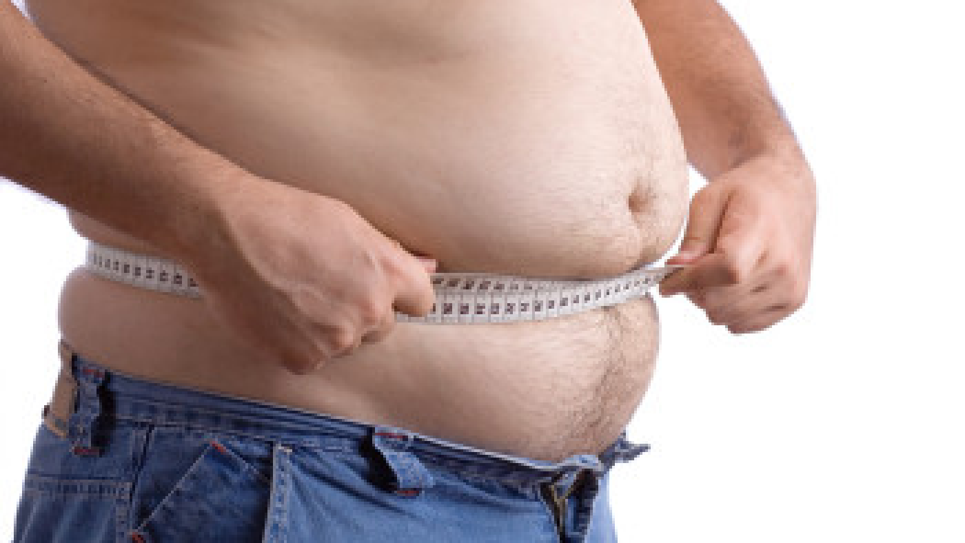 fat man holding a measurement tape