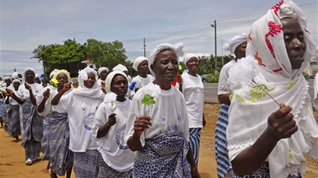 Liberia women sing after praying for help with the Ebola virus, in the city of Monrovia, Liberia. Thursday, Aug. 14, 2014. Liberia faced an excruciating choice Thursday: deciding which handful of Ebola patients will receive an experimental drug that could prove either life-saving or life-threatening. ZMapp, the untested Ebola drug, arrived in the West African country late Wednesday. (AP Photo/Abbas Dulleh)