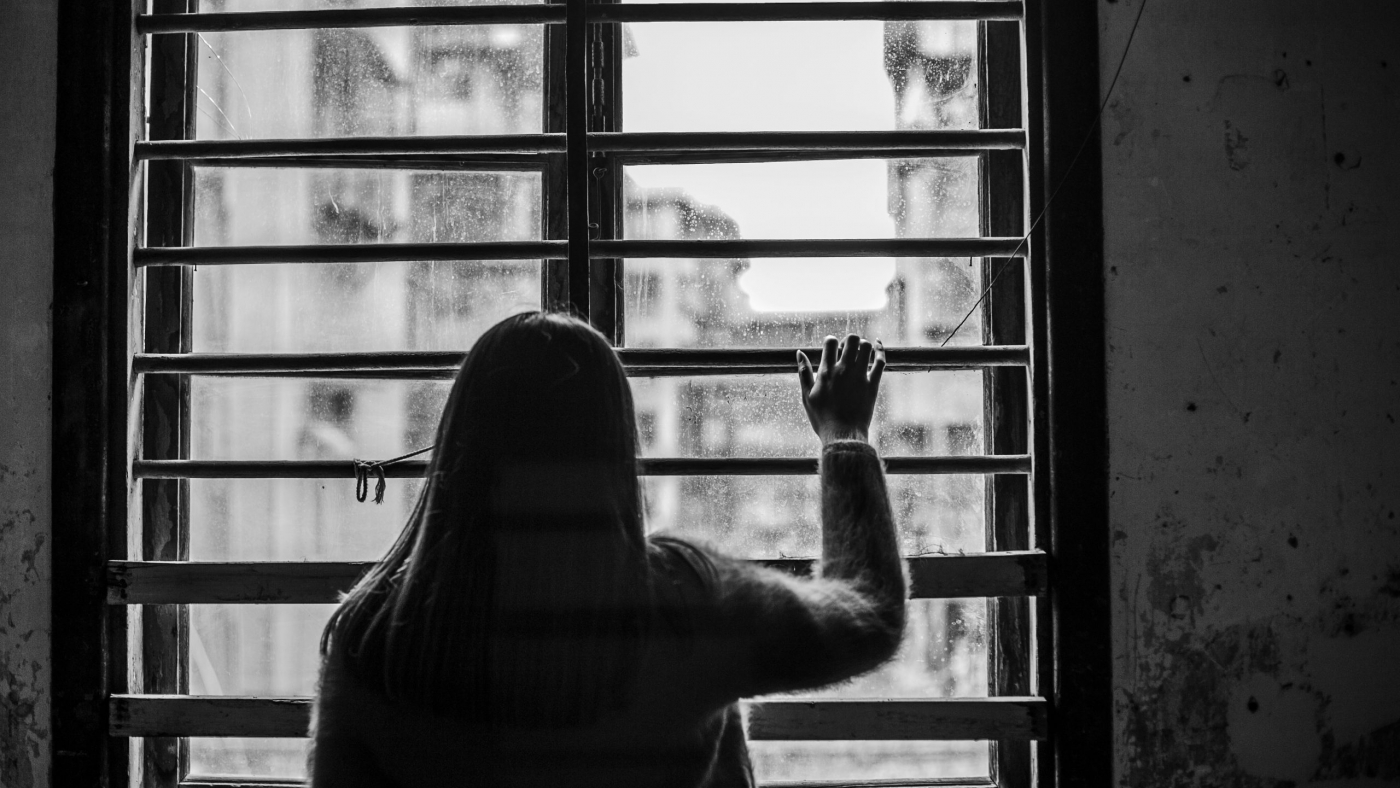 rear-view-sad-woman-window