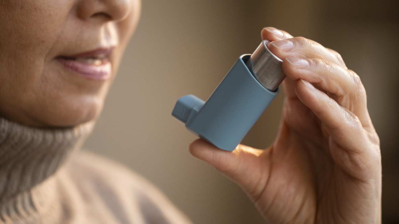 senior-woman-holding-asthma-inhaler