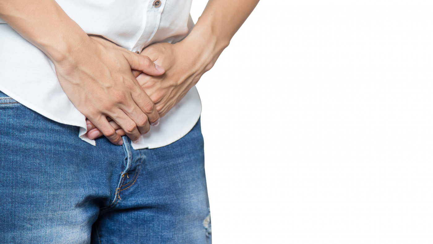 Male hands holding on middle crotch of trousers with prostate inflammation, Prostate cancer, Men's health care concept isolated on white.