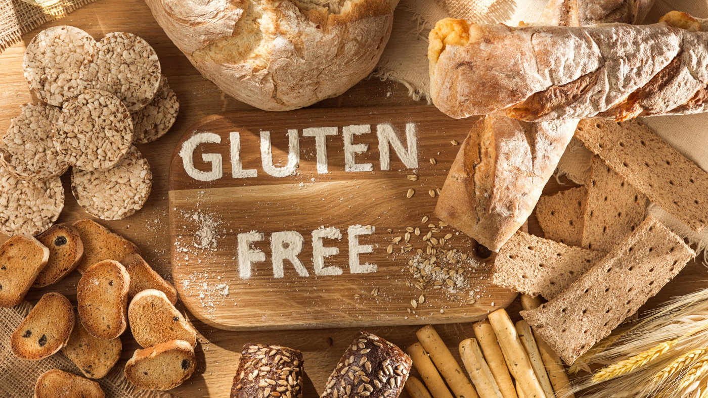 Gluten free food. Various pasta, bread and snacks on wooden background from top view. Healthy and diet concept.