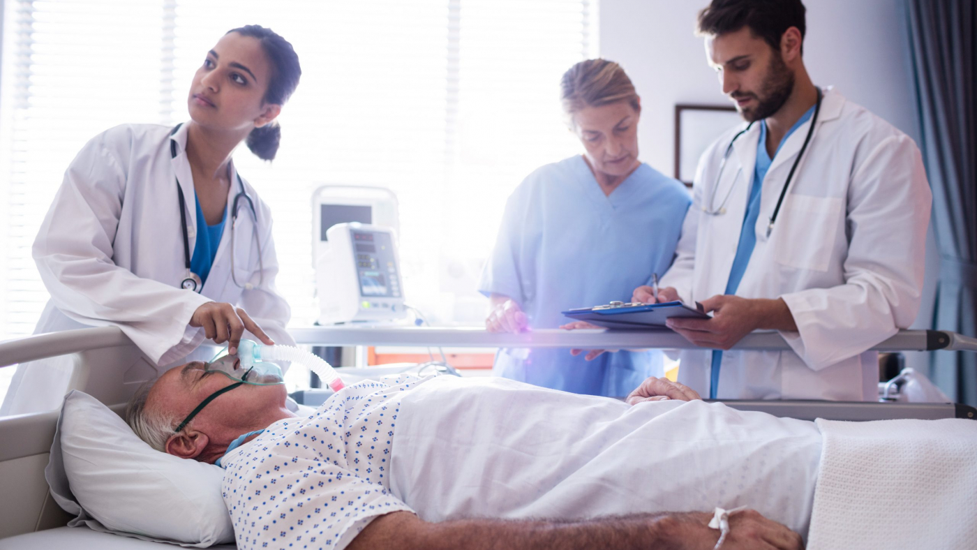 Female doctor putting oxygen mask on patient face in the hospital