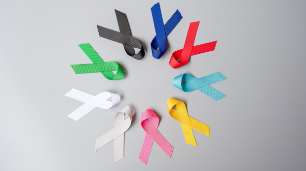 World cancer day (February 4). colorful awareness ribbons; blue, red, green, black, grey, white, pink and yellow color for supporting people living and illness. Healthcare and medical concept