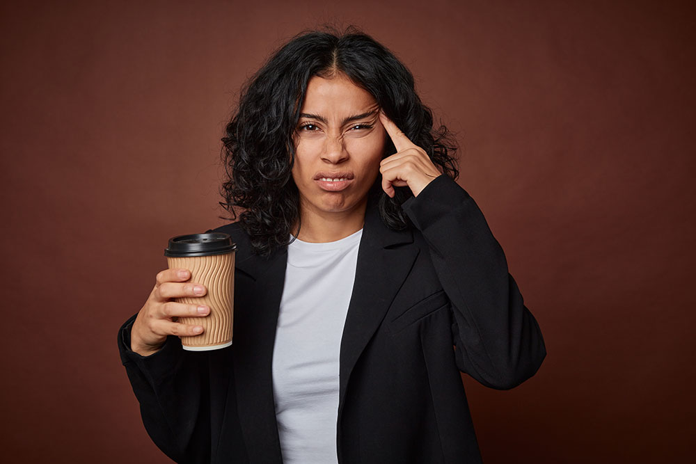 Coffee Drinker Head Hurts from Caffeine and Anxiety