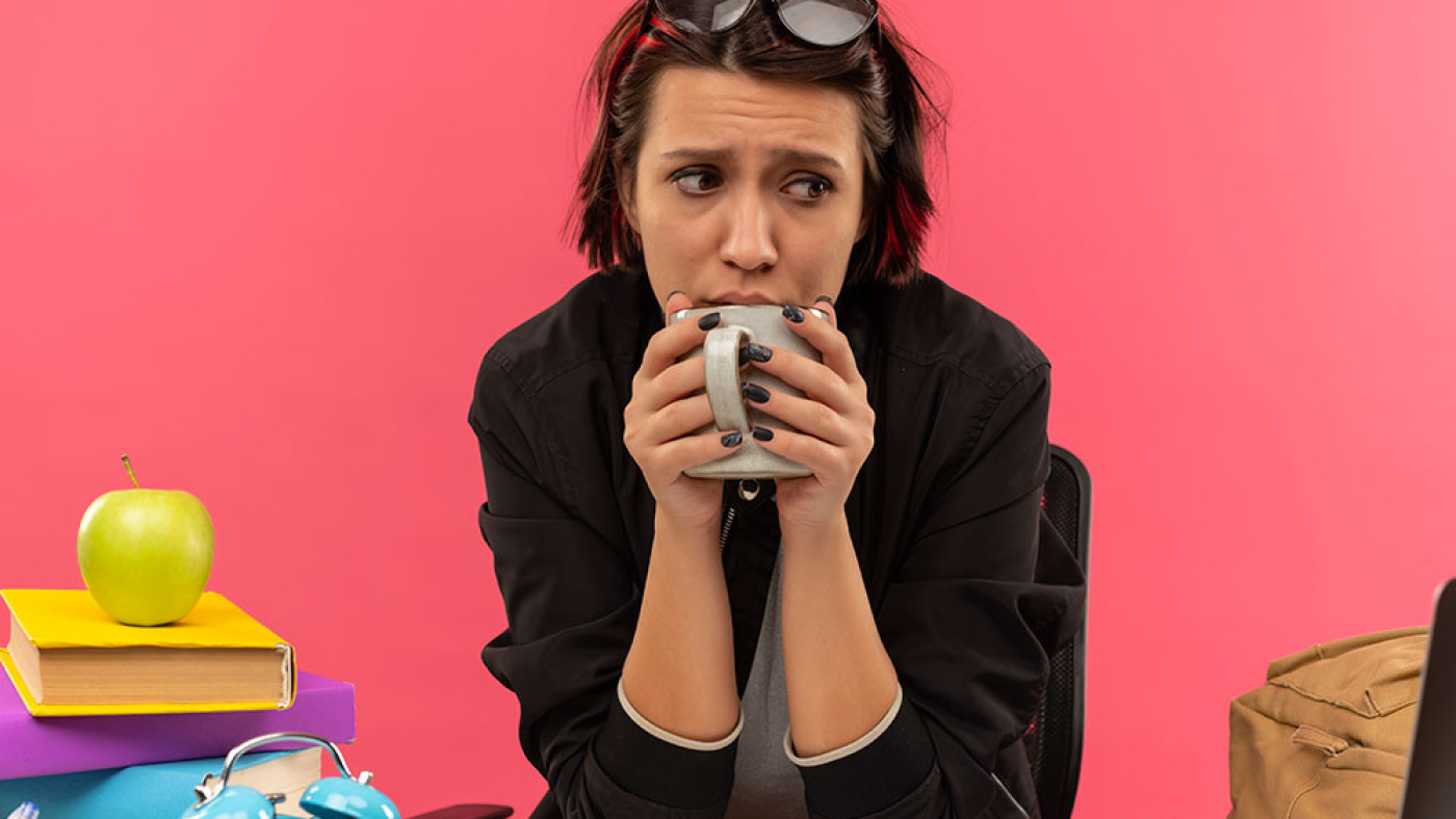 Worries and Anxious Student Drinks Cup of Coffee