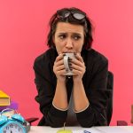 Worries and Anxious Student Drinks Cup of Coffee