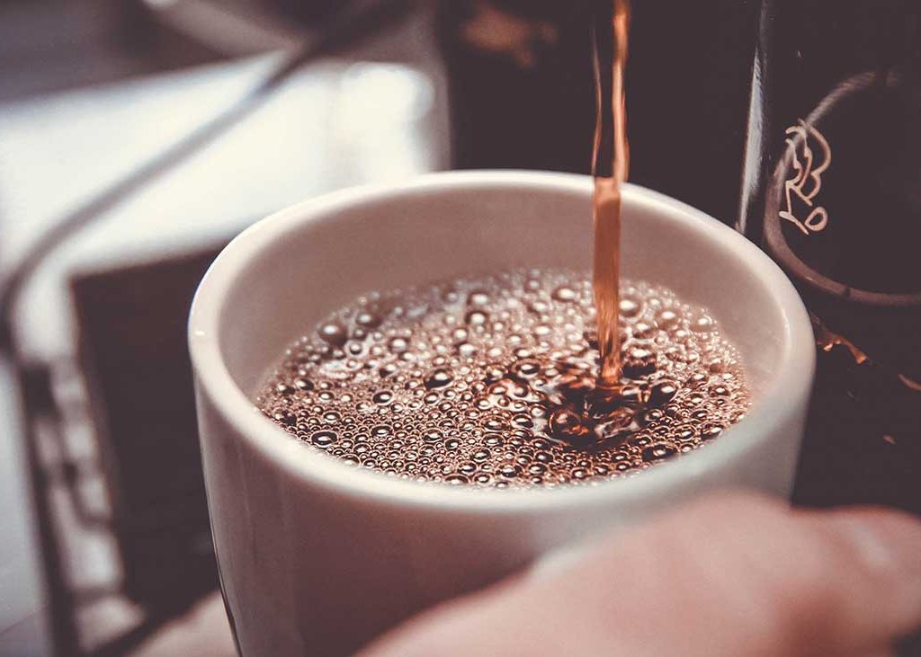 Fresh Coffee Being Poured into Cup Article About Caffeine Effect