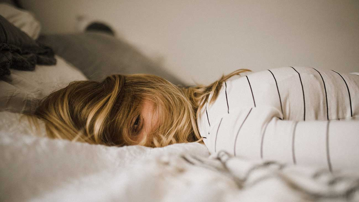 Insomnia and Depression Relationship Types and Causes Photo of Woman Lying Down