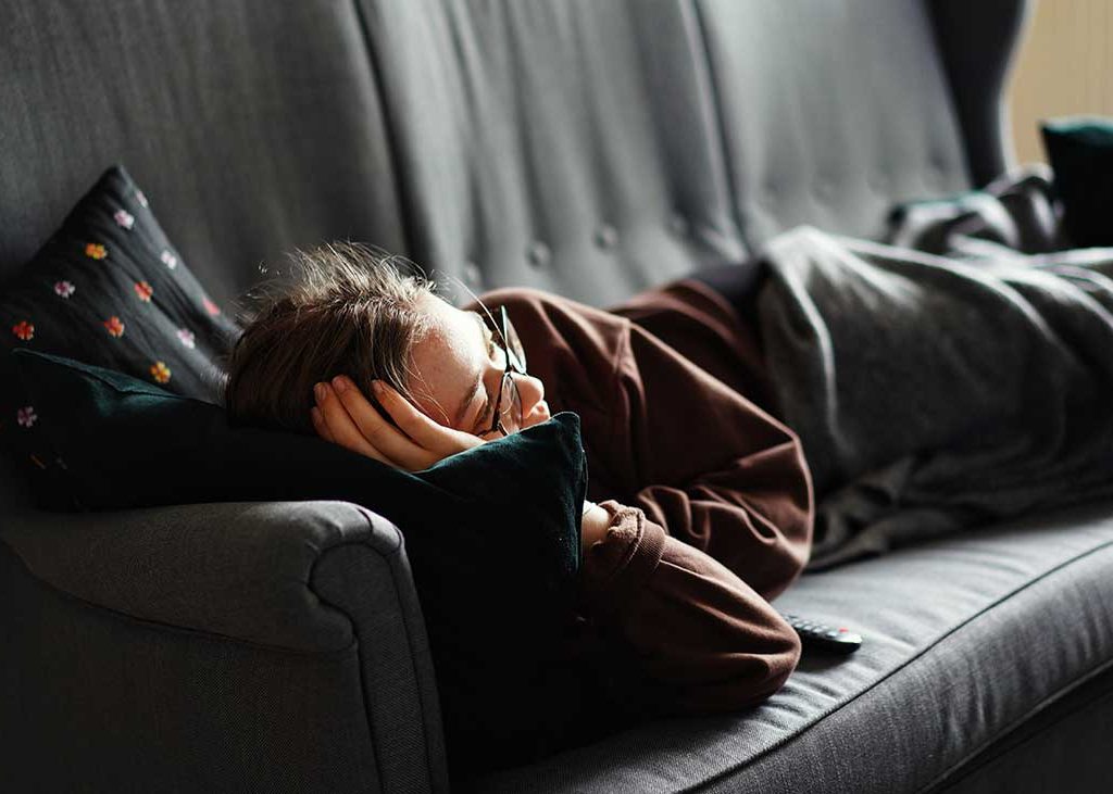 Young Man Lazy from the Lyinh on Couch Dpressed