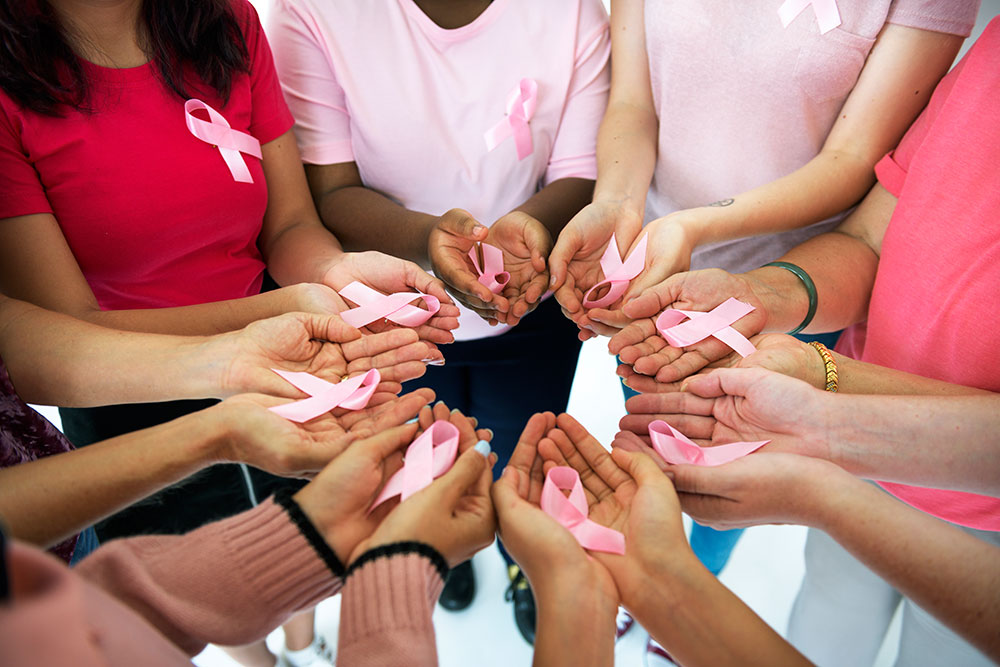 Breast Cancer Awareness Circle of Women Holding Out Hands with Pink Ribbons
