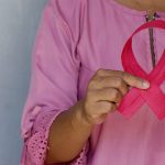 Women with Breast Cancer Holding up Pink Ribbon