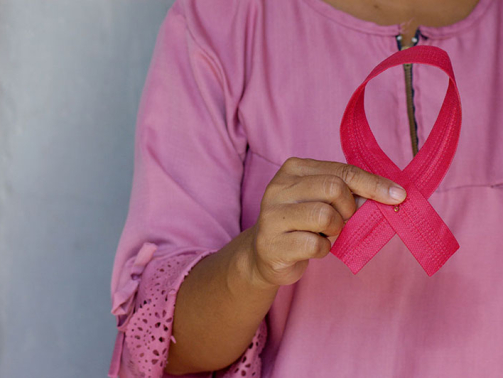 Women with Breast Cancer Holding up Pink Ribbon