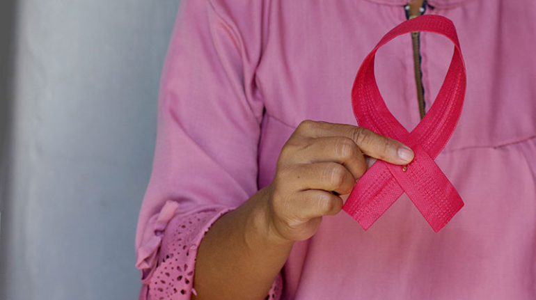 Women with Breast Cancer Holding up Pink Ribbon