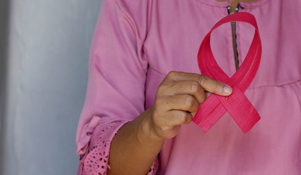 Women with Breast Cancer Holding up Pink Ribbon