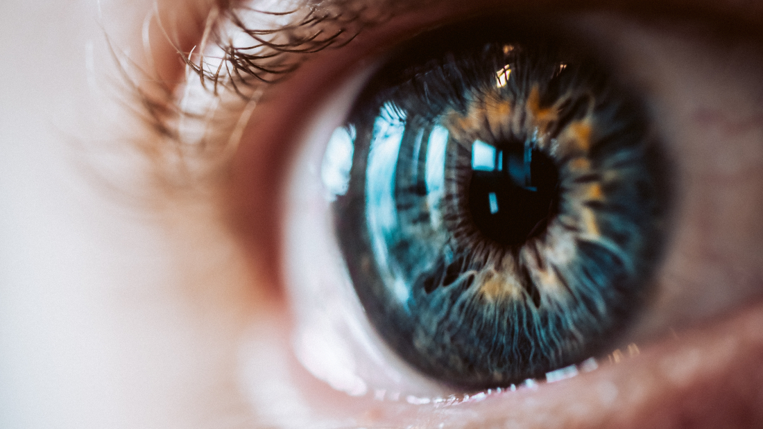 An extreme closeup of an enlarged human eye with beautiful colors