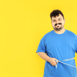 Man measuring his own waist