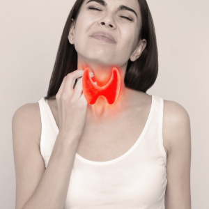 Woman touching neck, thyroid gland highlighted, representing endocrinology clinical trials
