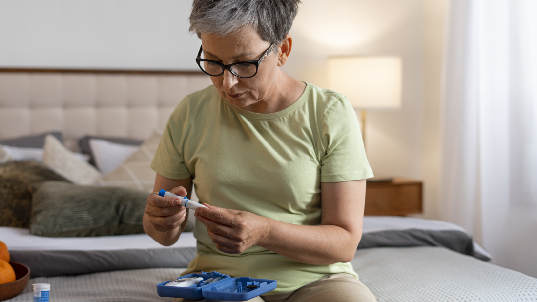 Woman checking blood sugar levels at home as part of monitoring for metabolic or lipid disorders like hypertriglyceridemia.