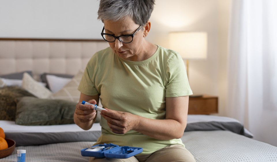Woman checking blood sugar levels at home as part of monitoring for metabolic or lipid disorders like hypertriglyceridemia.